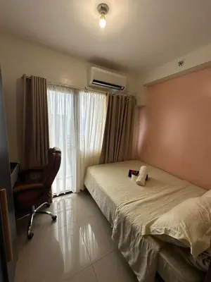 a bedroom with a bed and a chair and a window at Smdc shore 2 tower 2 in Manila
