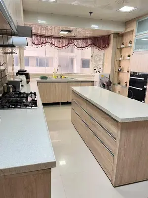 a large kitchen with a stove and a sink at R&R Entire Rental Unit in Manila