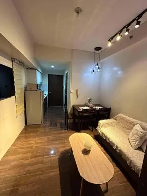 a living room with a couch and a table at AIR Residences Makati Holiday Home in Manila