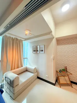 a living room with a couch and a table at Relaxing and Comfy in Manila
