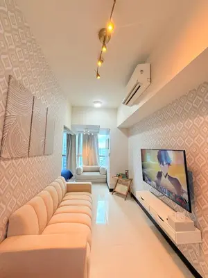 a living room with a couch and a flat screen tv at Relaxing and Comfy in Manila