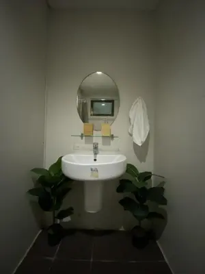 a bathroom with a white sink and a mirror at Prime Location Affordable Studio Condo in Legaspi village, Makati with Fast WiFi in Manila