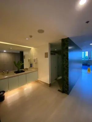 a large room with a kitchen with blue lights at Prime Location and Affordable Studio Condo in Legaspi Village, Makati with City view in Manila