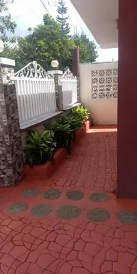 a patio with a white bench on a brick floor at CasaCavite - Your Chill Hideaway and Mini-Resort Just Minutes from all the Tagaytay-Silang-Nuvali Action! in Silang