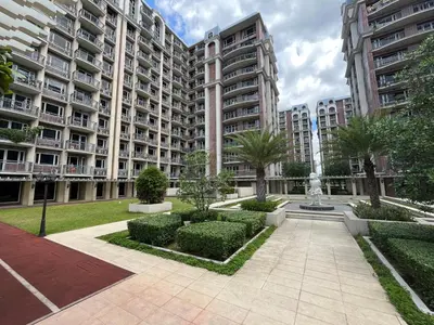 a large apartment building with a fountain in a courtyard at Monarch Park-suites Condominium in Manila