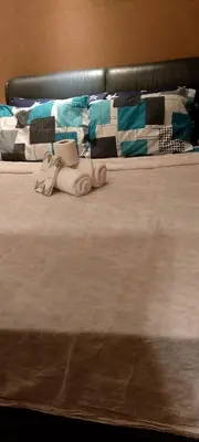 a bed with a baby doll laying on it at Shell Residence in Manila