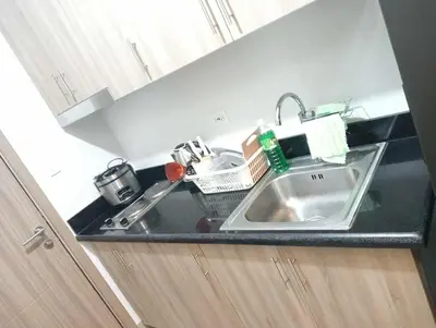 a kitchen counter with a sink in a kitchen at la Chicka - 295 T3 in Manila