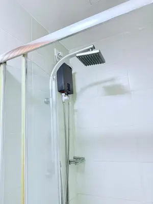 a shower with a shower head in a bathroom at 42nd Floor 2BR with Stunning Views & 7 Pools in Manila