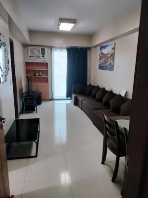 a living room with a couch and a table at 1 Bedroom Near Airport by Rqui in Manila