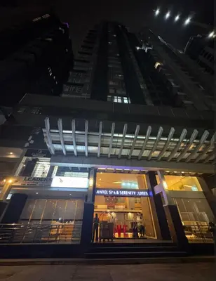 a store front of a tall building at night at Folks Hub in Manila