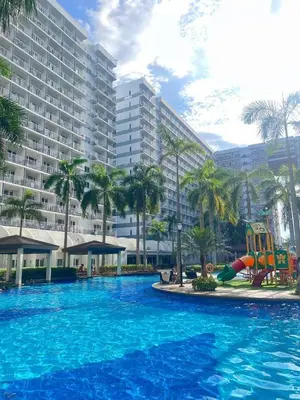 a large swimming pool in front of a large building at Moa shell residence pasay city in Manila
