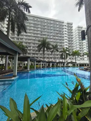 an empty swimming pool in front of a large building at Moa shell residence pasay city in Manila