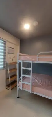 a room with two bunk beds and a ceiling at JACC Condotel in Manila