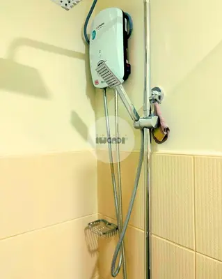 a shower in a bathroom with a hair dryer at iWandr Suites at SMDC Charm Residences in Manila