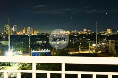 a view of a city skyline at night at iWandr Suites at SMDC Charm Residences in Manila