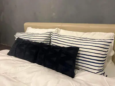 a pile of pillows sitting on top of a bed at Amaia step parkway nuvali studio in Calamba