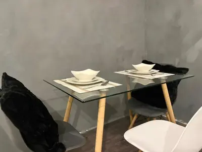 a glass table with two bowls and plates on it at Amaia step parkway nuvali studio in Calamba