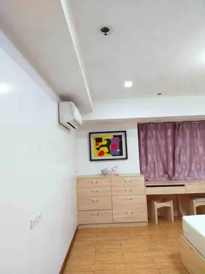 a bedroom with a bed and a dresser and a window at R&R Empire Rental Unit in Manila