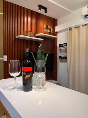 a bottle of wine and a glass on a counter at Win-Ter Staycation 1 in Manila