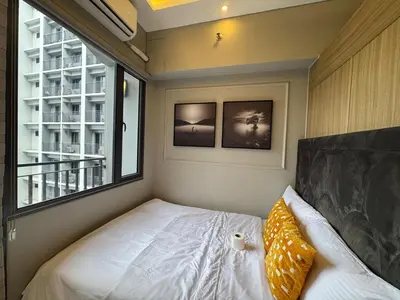 a small bedroom with a bed and a window at Home of Mari in Shore 2 Residences Room 10107 near Airport, SM MOA, US Embassy Manila by Prime Stay MOA in Manila