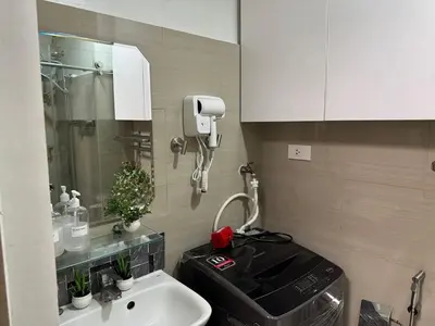 a bathroom with a sink and a phone on the wall at Home of Mari in Shore 2 Residences Room 10107 near Airport, SM MOA, US Embassy Manila by Prime Stay MOA in Manila