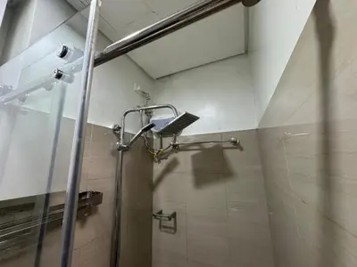 a shower in a bathroom with a glass door at Home of Mari in Shore 2 Residences Room 10107 near Airport, SM MOA, US Embassy Manila by Prime Stay MOA in Manila