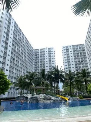 a swimming pool in front of two large buildings at Shore 1 Tower D in Manila