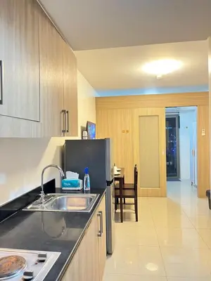 a kitchen with a sink and a counter top at Shore 1 Tower D in Manila