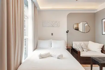 a bedroom with two beds and a window at Central Modern Cosy Condo in Makati - The Linear Suite in Manila