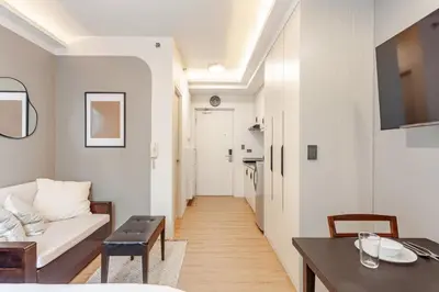 a living room with a couch and a table at Central Modern Cosy Condo in Makati - The Linear Suite in Manila