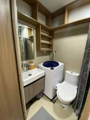 a small bathroom with a toilet and a sink at Shore Condotel pasay manila in Manila
