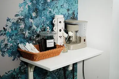 a counter with a coffee maker and a basket on it at Blue Horizon - Newly renovated condo near MOA in Manila