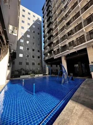 an empty swimming pool in the middle of a building at Lemon Room in S Residences near MOA, Airport, US Embassy by Prime Stay in Manila
