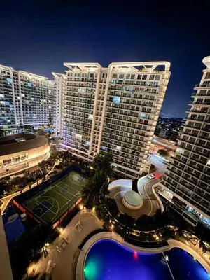 a large building with a tennis court in front of it at A2Z Staycation Miami Tower 15th Floor With Ps4 and Netflix in Manila