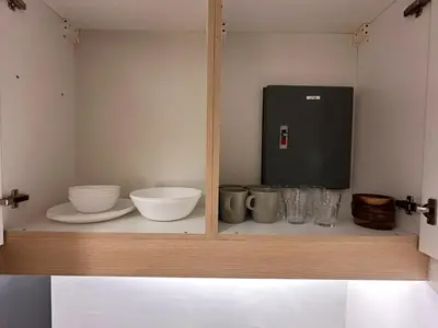 a shelf with bowls and other items on it at 1BR Corner Unit with Balcony in Manila