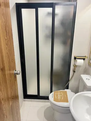 a bathroom with a shower with a toilet and a sink at Condo Azure Urban Resort Paranaque in Manila