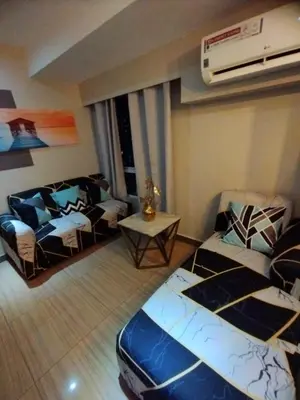 a living room with a couch and a table at Urban Nest in Manila