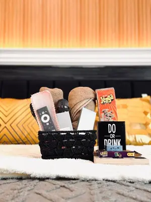 a basket of food and books on a table at Azure Urban Resort paranaque in Manila