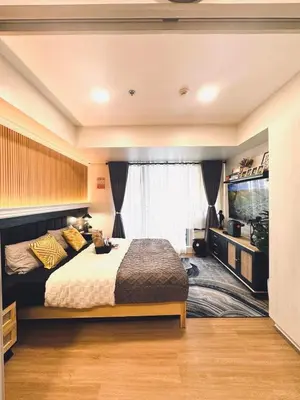 a bedroom with a bed and a large window at Azure Urban Resort paranaque in Manila