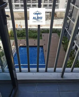 a sign on a window of a building with a swimming pool at Mall of Asia condotel shore 3 tower 2 in Manila