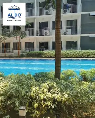 a swimming pool in front of a building at Mall of Asia condotel shore 3 tower 2 in Manila