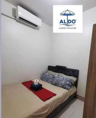 a bedroom with a bed with a black head board at Mall of Asia condotel shore 3 tower 2 in Manila