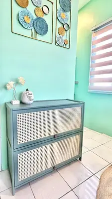 a dresser in a room with a blue wall at Enchanted Home - Near Enchanted Kingdom in Santa Rosa