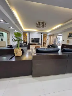 a large living room with couches and a television at R&R Entire Rental Unit in Manila