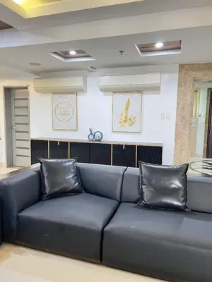 a large blue couch in a living room at R&R Entire Rental Unit in Manila