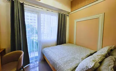a bedroom with a bed and a large window at Elegant with Best View Fast Wifi Mall of Asia Airport in Manila