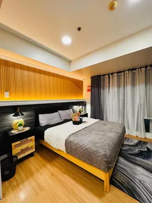 a bedroom with a large bed and a window at Azure Urban Resort paranaque velvet horiyama in Manila