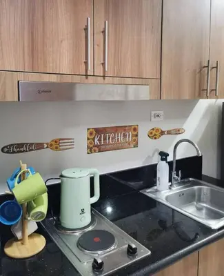 a kitchen with a sink and a counter top at Mall of Asia condotel shore 3 residence in Manila
