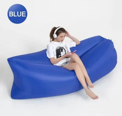 a young girl sitting on a blue couch with a cell phone at 2br Beach KTV Condo in MOA SMX Okada, Near Airport in Manila