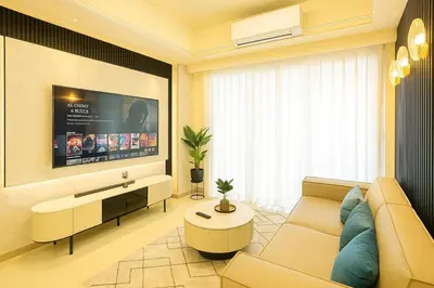 a living room with a couch and a tv at Luxurious 3BR near Solaire & Okada w Infinity Pool in Manila